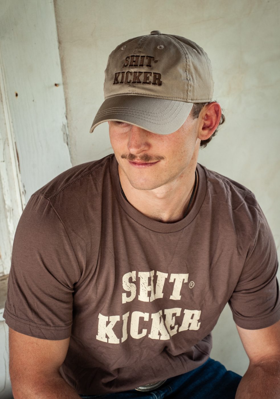 Model in a cocoa Shit Kicker tee